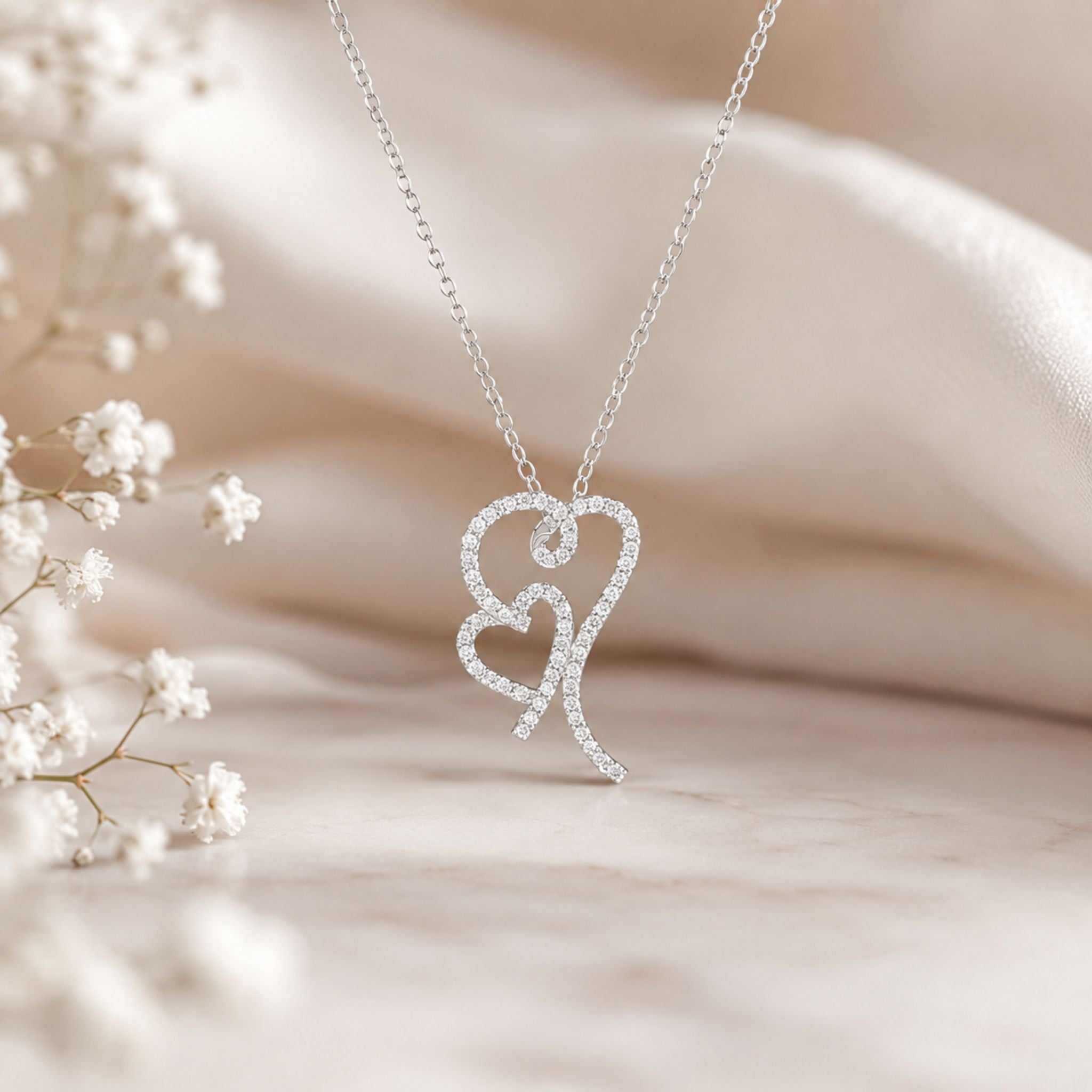 Interlocking heart pendant adorned with sparkling lab-grown diamonds